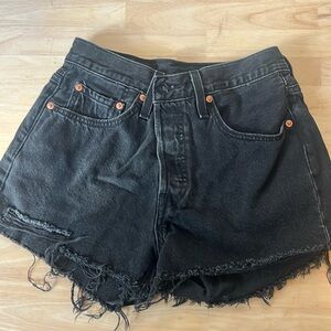 Black Levi 501 jean shorts with some distressing at the bottom